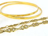 two gold bracelets, a ring, and a bracelet with a chain