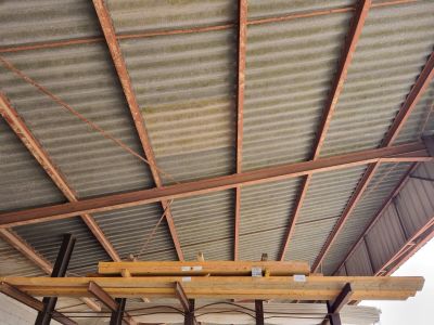 a picture of a ceiling with metal roofing and wood beams
