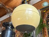 a yellow ball hanging from the ceiling in a room