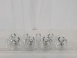 five clear glass vases sitting on a white counter