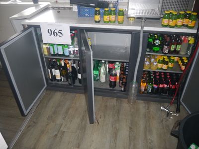 a refrigerator that has a lot of bottles of beer in it