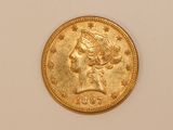 a close up of a gold coin with a woman ' s head on it