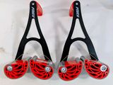 two pairs of red and black tennis rackets on a white surface