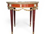a small table with a marble top and red legs