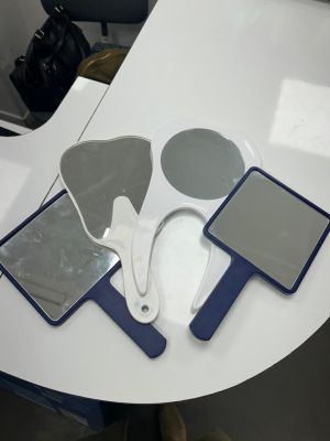 a table with a mirror, mirror and a pair of shoes on it