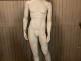 a white mannequin in a room with a checkered floor