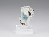 a close up of a piece of rock with a white base