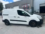 a white van parked in front of a building in a parking lot