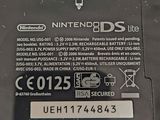 a close up of a nintendo ds lite label on the back of a nintendo ds lite