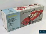 a box with a model of a red car in it