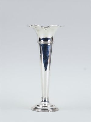 an image of a silver vase sitting on top of a table