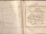 an open book with a map on it sitting on a table