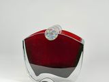a red glass vase with a silver base on a white background
