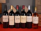 several bottles of wine are lined up on a table