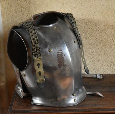 a metal helmet on a wooden table in a room