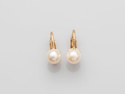 a pair of pearl earrings on a white background