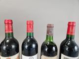 several bottles of wine are lined up on a table