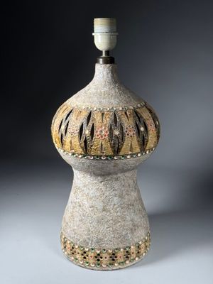 a vase that has a light on top of it