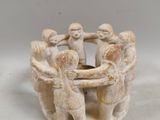 an image of a group of figurines holding hands