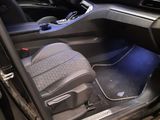 the interior of a car with the door open and the driver ' s seat up