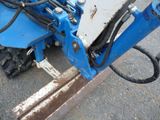 a blue machine that is sitting on the ground