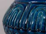 a blue vase with a decorative design on it
