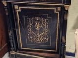 a black cabinet with a gold design on it