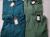 two men ' s jackets with tags on them sitting on a table
