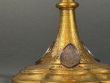 a gold plate with a bird on top of it