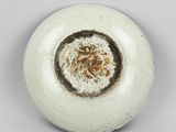 a white plate with a brown design on it