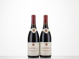 two bottles of wine sitting on top of a table