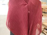 red shawl draped over a mannequin in a warehouse