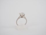 a close up of a diamond ring on a white background