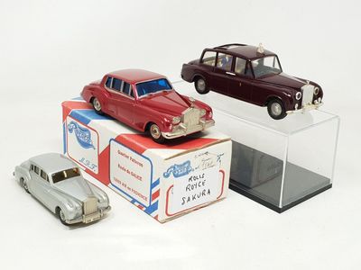 three toy cars that are on display on a white surface