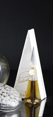 a bottle of perfume and a box of perfume on a table