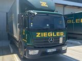 two trucks that are parked in front of a building
