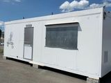 an image of a white container house in a parking lot