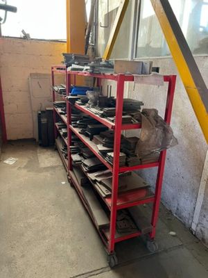 a rack of tools in a garage with a lot of shelves