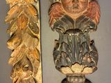 two decorative carvings on the wall next to each other