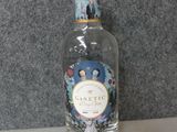 a bottle of gin on a counter with a cork stopper