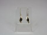 a pair of silver earrings with black stones on them