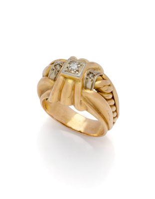 a close up of a gold and diamond ring on a white background