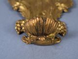 a gold plate with a flower on it on a blue surface