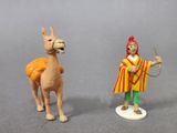 two figurines of a camel and a man on a horse