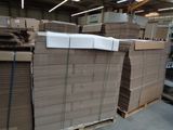 a lot of cardboard boxes stacked on top of each other in a warehouse
