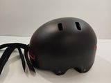 a black helmet on a white surface with a black strap
