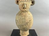 an image of a stone sculpture of a head on a black base