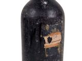 a black bottle with a pink cap on it