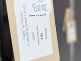 a tag hanging from a metal frame with a tag attached to it