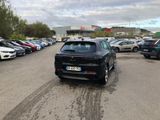 a lot of cars parked in a parking lot on a cloudy day